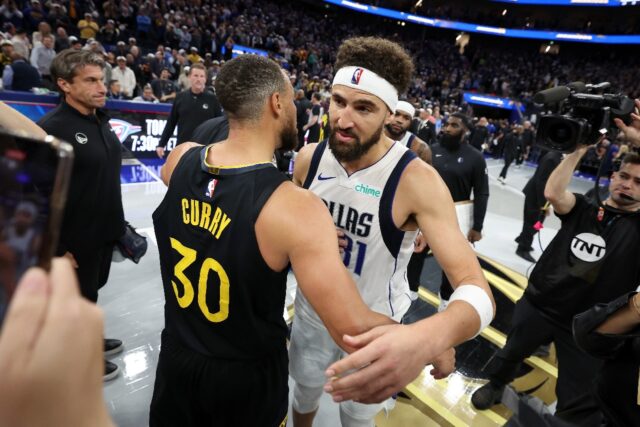 Dallas Mavericks star Klay Thompson (right) hugs former Golden State teammate in his first