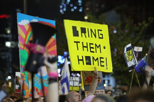 Hundreds of Israelis demonstrate in commercial hub Tel Aviv for a truce deal to bring the