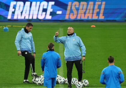 Israel head coach Ran Ben Shimon addresses his players in training before their match agai