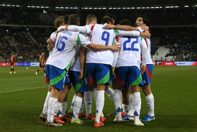 Italy hug to celebrate after Sandro Tonali (R) scored the winning goal