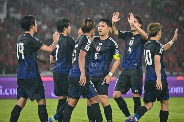 Japan hammered a hapless Indonesia side 4-0 on Friday, extending their lead at the top of