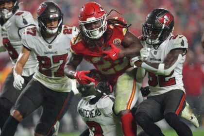 Kareem Hunt of the Kansas City Chiefs carries the ball as Zyon McCollum, Jordan Whitehead,