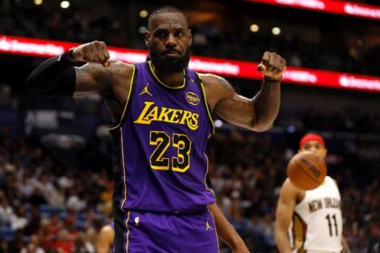 LeBron James of the Los Angeles Lakers reacts after scoring in his team's 104-99 NBA trium