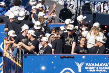 Los Angeles Dodgers star Shohei Ohtani, center, celebrates with his teammates in a parade