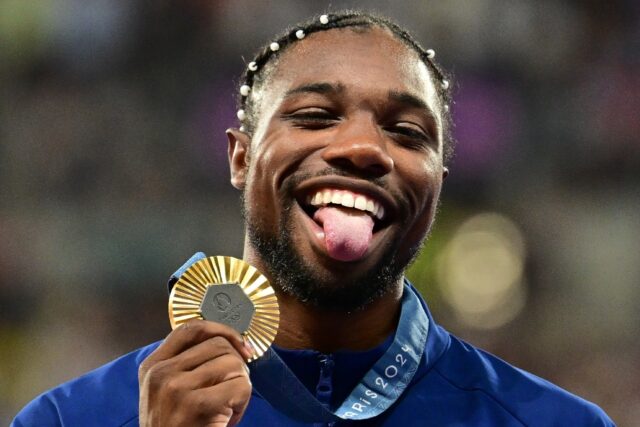 Noah Lyles with his Olympic 100m gold medal - but it wasn't enough to earn him a chance to