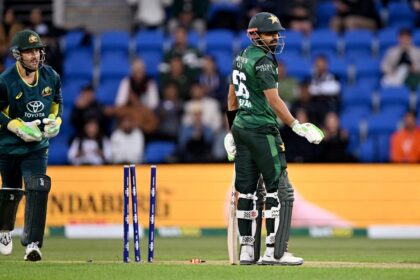 Pakistan batsman Babar Azam (R) reacts after being bowled during the third T20 against Aus