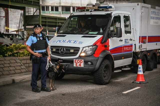 Police keep watch outside the West Kowloon Magistrates' Court in Hong Kong during the sent