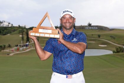 Rafael Campos of Puerto Rico poses with the trophy after winning his first US PGA Tour tit