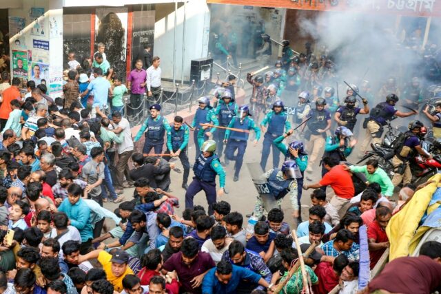 Security forces lobbed stun grenades and launched baton charges to break a crowd of protes