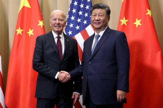 US President Joe Biden shakes hands with Chinese President Xi Jinping on the sidelines of