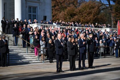 US President Joe Biden and Vice President Kamala Harris stand at attentiin before particip