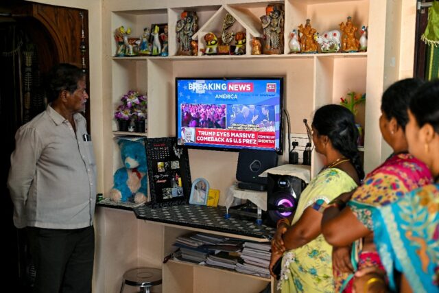 Villagers watch the 2024 US presidential election poll results inside a house in Vadluru,