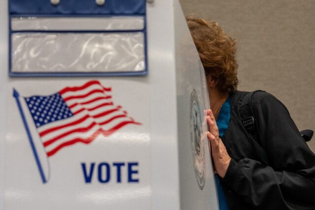 A woman casts her ballot at a New York voting precinct on November 1, 2024