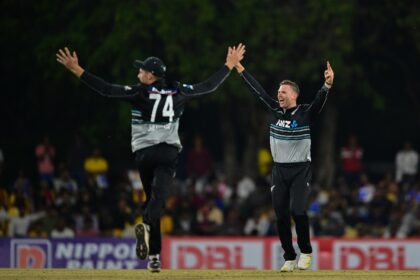 New Zealand's Lockie Ferguson (R) celebrates after taking the wicket of Sri Lanka's captai