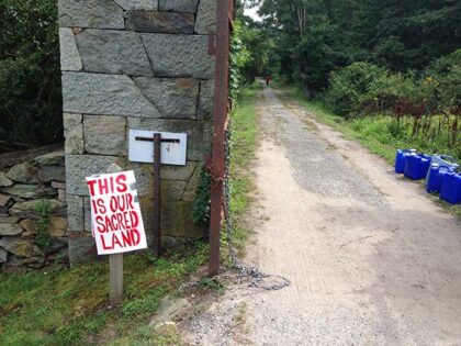 A sign is posted on Brown University land in Bristol, R.I. on Monday, Aug. 21, 2017. Dozen