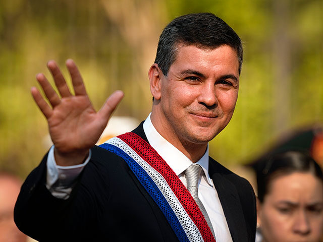 Paraguay's President Santiago Pena waves before a military parade during his inauguration