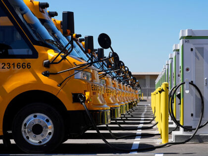 Zum electric buses are plugged into charging stations before a news conference announcing