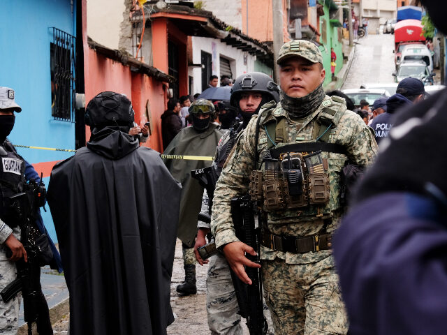 Soldiers, National Guards and police cordon off the site where Catholic priest Marcelo Per