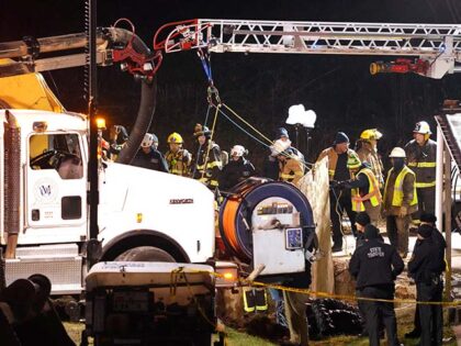 Rescue workers search in a sinkhole for Elizabeth Pollard, who disappeared while looking f