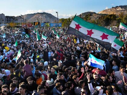 Syrians celebrate during a demonstration following the first Friday prayers since Bashar A