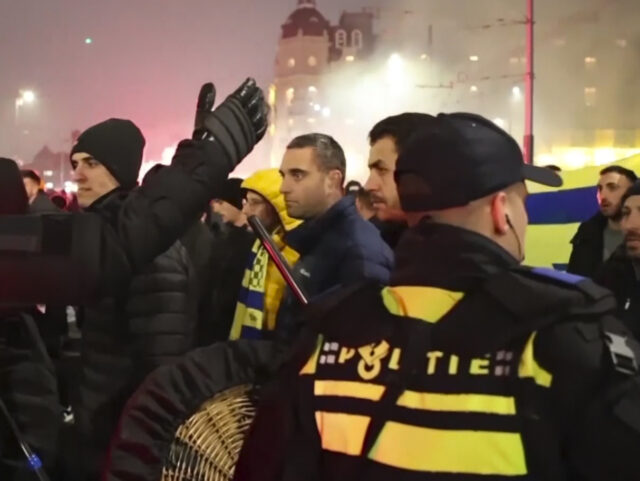 FILE - In this image taken from video, police escort Maccabi Tel Aviv supporters to the me