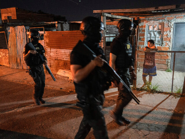 Police patrol in the 7 de Septiembre neighborhood of Rosario, Argentina, Tuesday, Nov. 12,