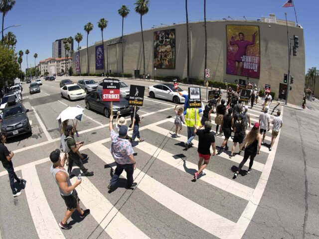 Striking writers and actors take part in a rally outside Warner Bros. studios in Burbank,