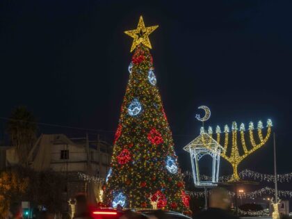 People celebrate with Christmas decorations in Haifa, Israel, Monday, Dec. 23, 2024. (AP P