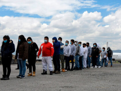 Guatemalan migrants deported from the United States, queue upon their arrival at the Air F