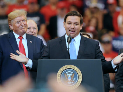 U.S. President Donald Trump looks on as Florida Governor Ron DeSantis speaks during the Fl