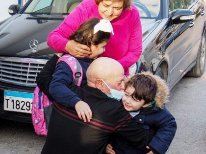 Suhail al-Hamwi (61) hugs his grandchildren in the coastal town of Chekka in northern Leba