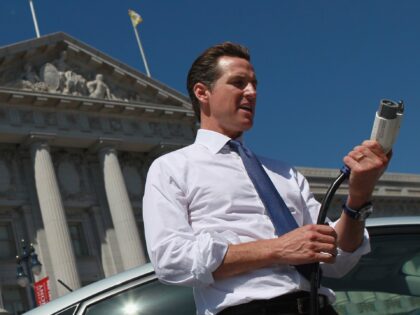 SAN FRANCISCO - AUGUST 25: San Francisco mayor Gavin Newsom holds a power cable before tes