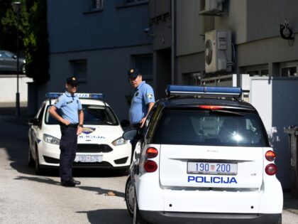 Police stands guard, on September 25 2021, near the flat where a man is suspected of killi