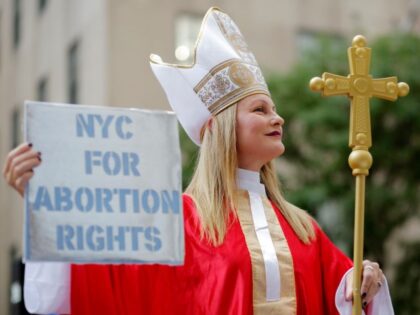 A woman in a Catholic cardinal costume attends the Abortion Carnival at St. Patrick's Cath