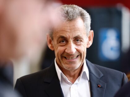 France's former president Nicolas Sarkozy looks on in a polling station during the vote of