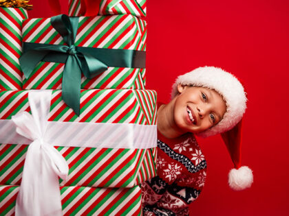 child with Christmas presents