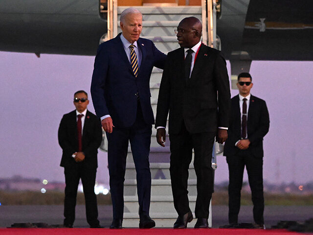 US President Joe Biden (3rd R) walks on the red carpet next to Angola Foreign Affairs Mini