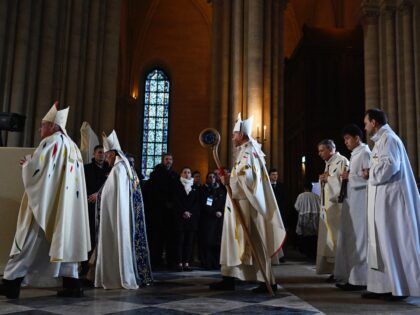 The Archbishop of Paris Laurent Ulrich (C) arrives to lead prayers for the consecration of