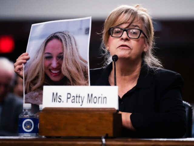 UNITED STATES - DECEMBER 10: Patty Morin holds a picture of her daughter, Rachel, who was