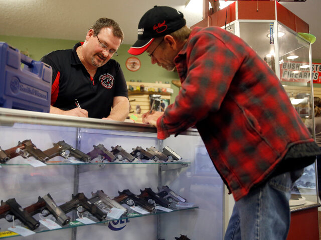 In this Saturday, Nov. 15, 2014 photo, Steven King, left, fills out paperwork while sellin