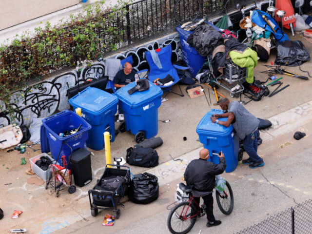 Unhoused people gather in an encampment on November 18, 2024 in San Diego, California. The