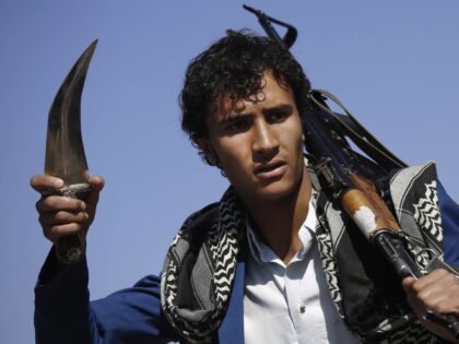 A Shiite fighter, known as Houthi, attends a tribal gathering showing support for the Hout