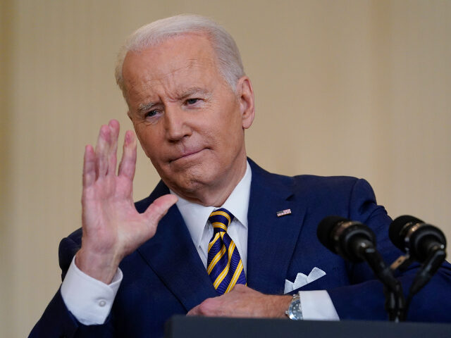 President Joe Biden gestures as he speaks during a news conference in the East Room of the