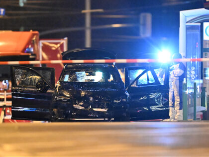 21 December 2024, Saxony-Anhalt, Magdeburg: Forensics are working on a car in which a perp