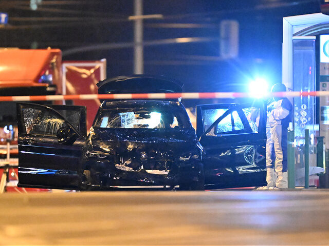 21 December 2024, Saxony-Anhalt, Magdeburg: Forensics are working on a car in which a perp