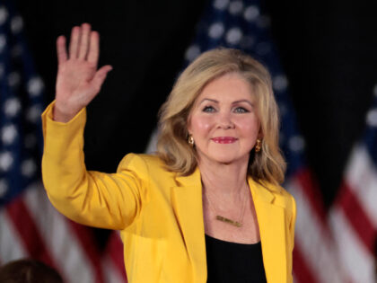 US Sen. Marsha Blackburn (R-TN) waves as she arrives for a town hall with former US Presid