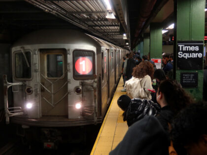 People wait to board a 1-line subway train at the Times Square station on November 12, 202