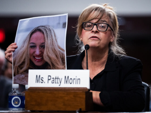 Patty Morin holds a picture of her daughter, Rachel, who was allegedly killed by undocumen