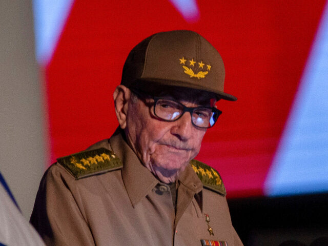 Former Cuban President Raul Castro looks at the Cuban flag during his speech at the event