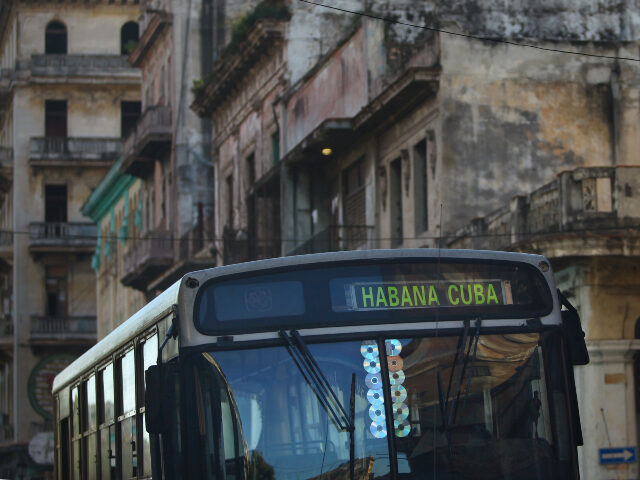 A city bus passes run-down buildings on December 28, 2015 in Havana, Cuba. Many of the cit